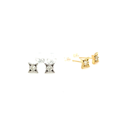 Pair of diamond stud earrings in gold and silver on a white background