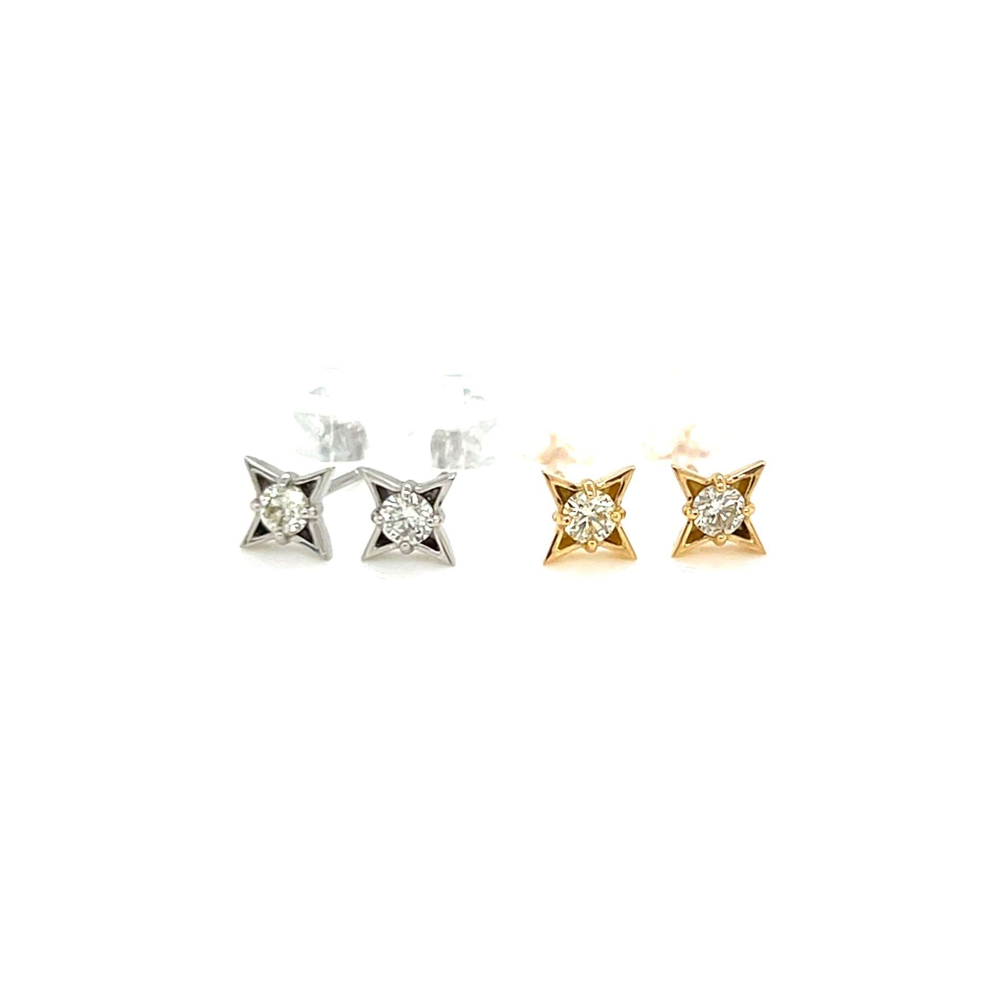 Pair of diamond four pointed star stud earrings on a white background