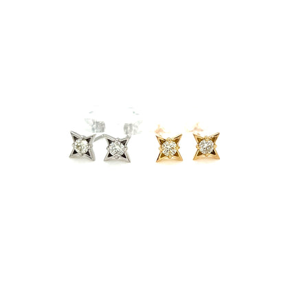 Pair of diamond four pointed star stud earrings on a white background