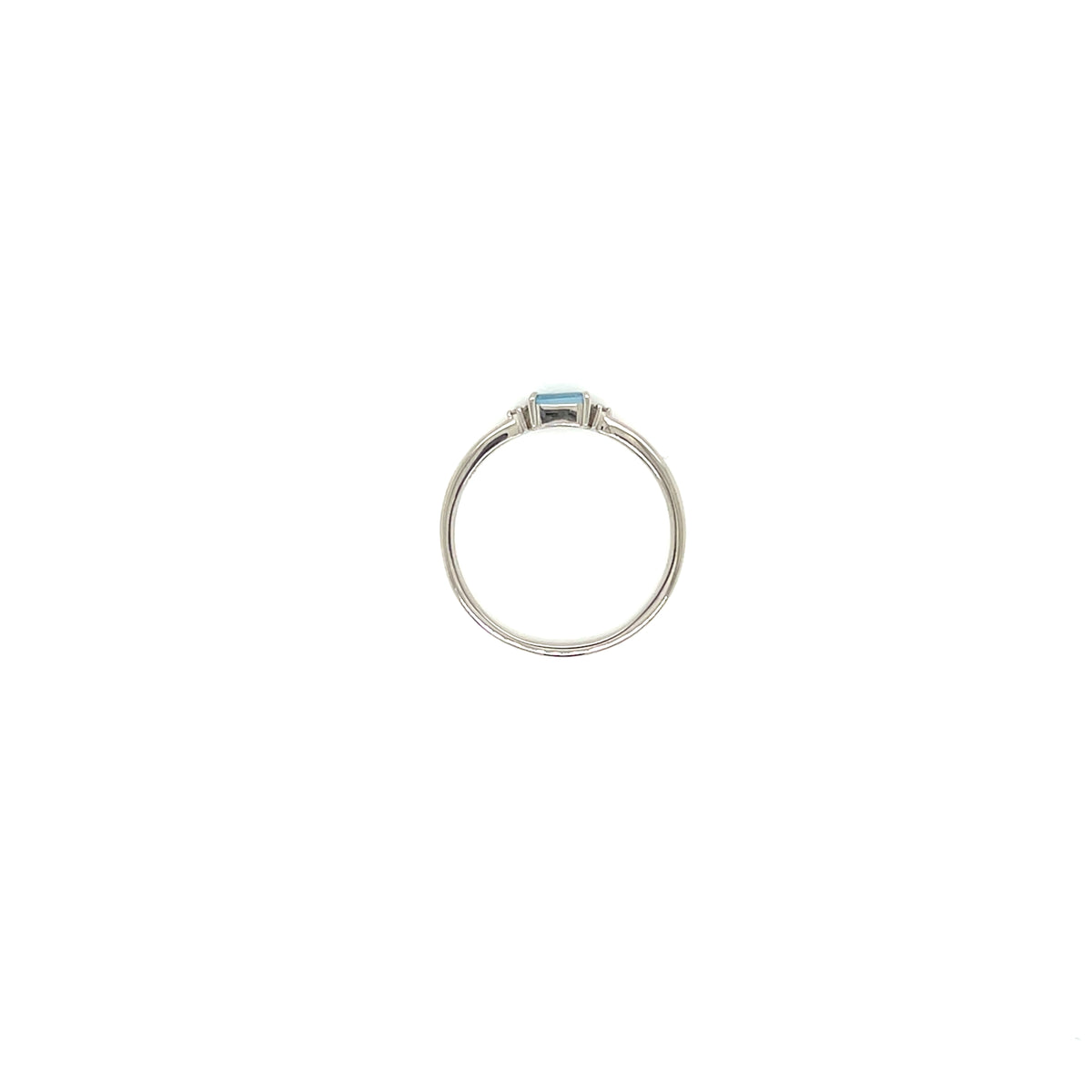 A silver ring featuring a small rectangular light blue gemstone in a bezel setting, centered on a plain white background.