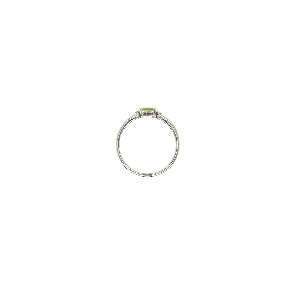 A silver ring featuring a small rectangular green peridot gemstone in a bezel setting, centered on a plain white background.