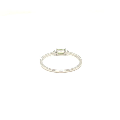 A silver ring with a single rectangular emerald-cut clear gemstone, shown on a plain white background.