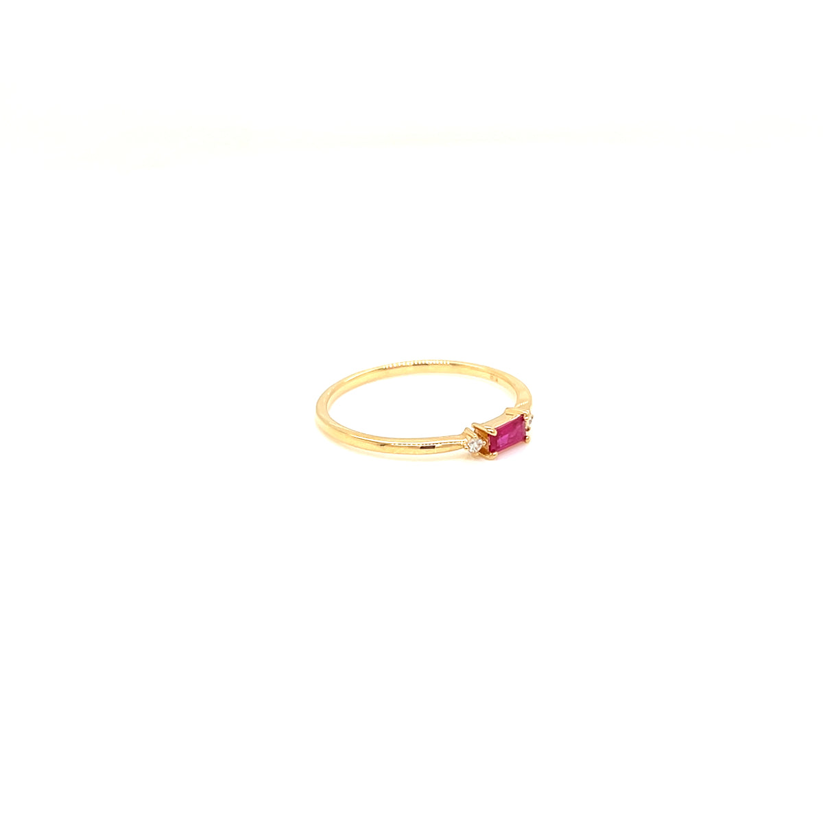 A delicate yellow gold ring featuring a small rectangular pink gemstone in a prong setting, photographed against a solid white background.