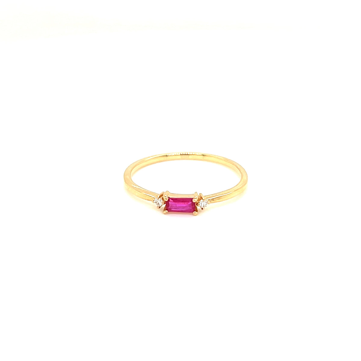 A delicate yellow gold ring featuring a small rectangular pink gemstone in the center, flanked by two tiny clear accent stones, set against a solid white background.