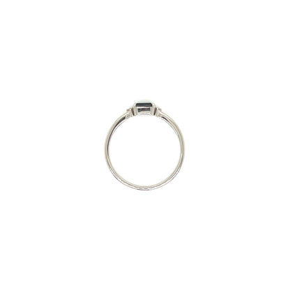 A silver ring with a small rectangular dark green gemstone, centered on a plain white background.