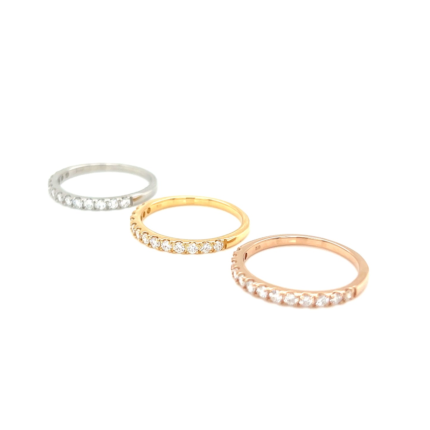 Three rings in silver, gold, and rose gold on a white background