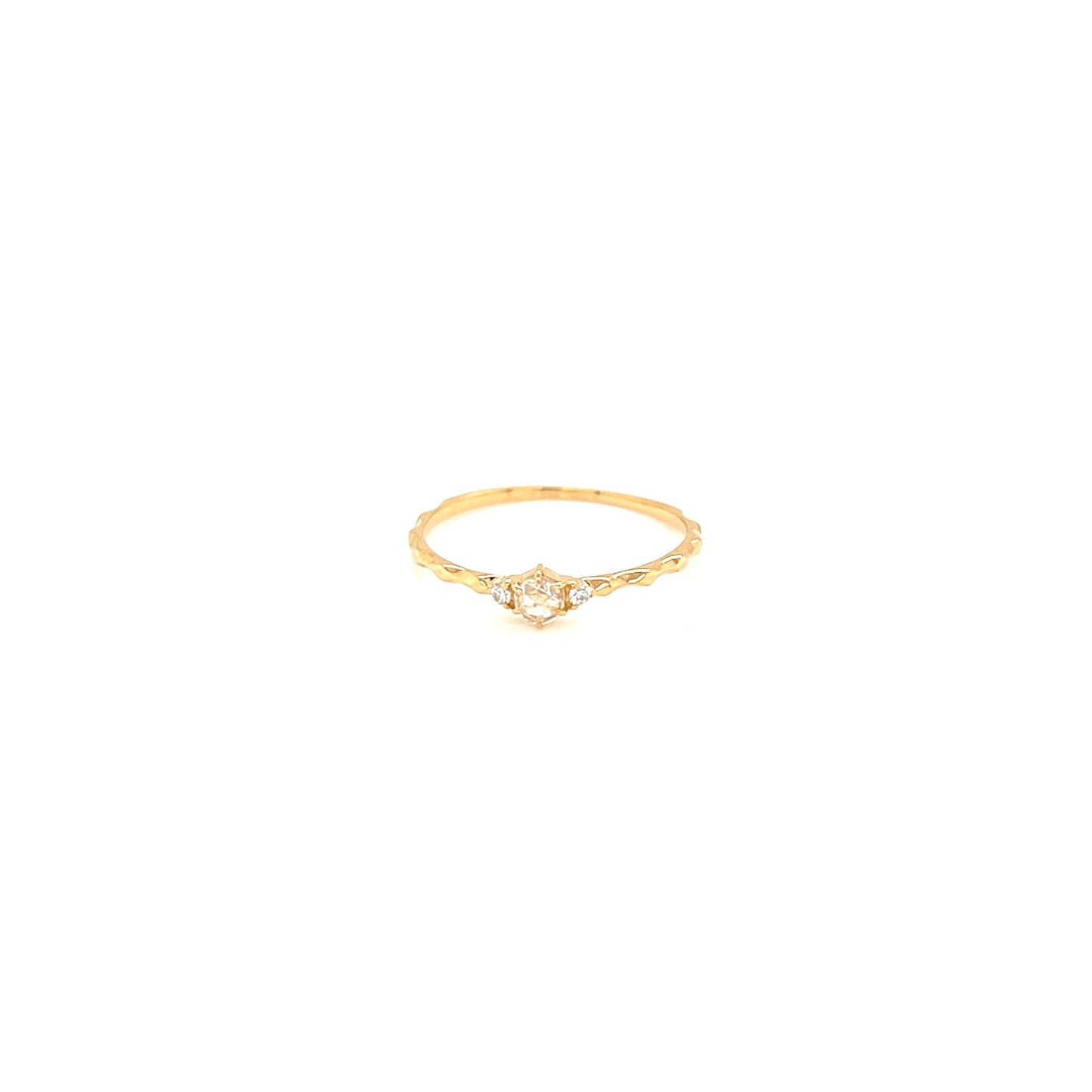 Gold ring with a small diamond on a white background