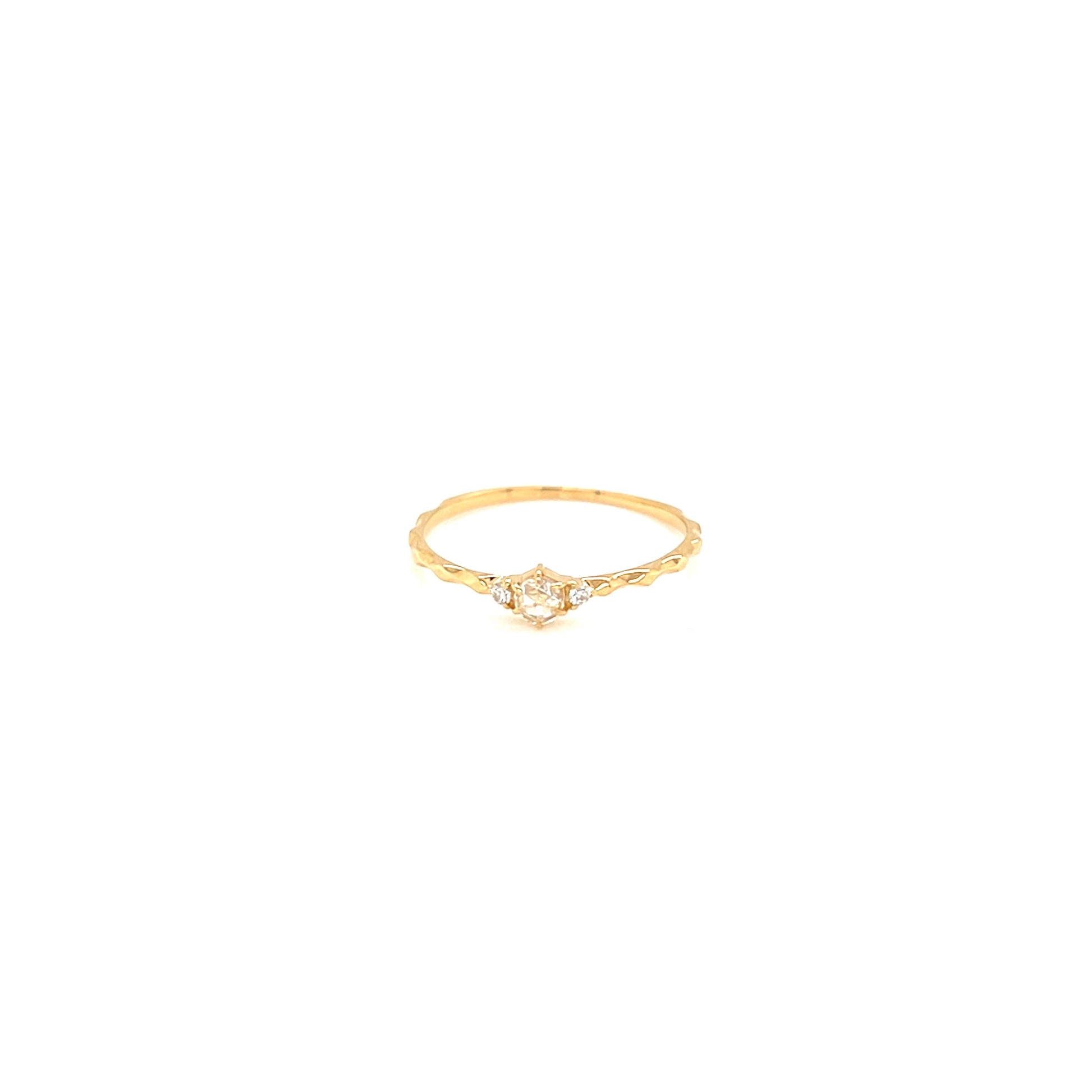 Gold ring with a small diamond on a white background