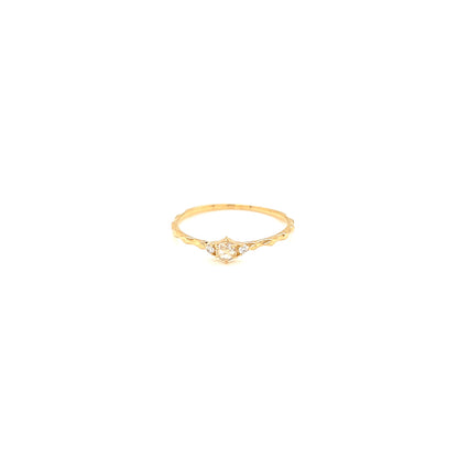 Gold ring with a small diamond on a white background