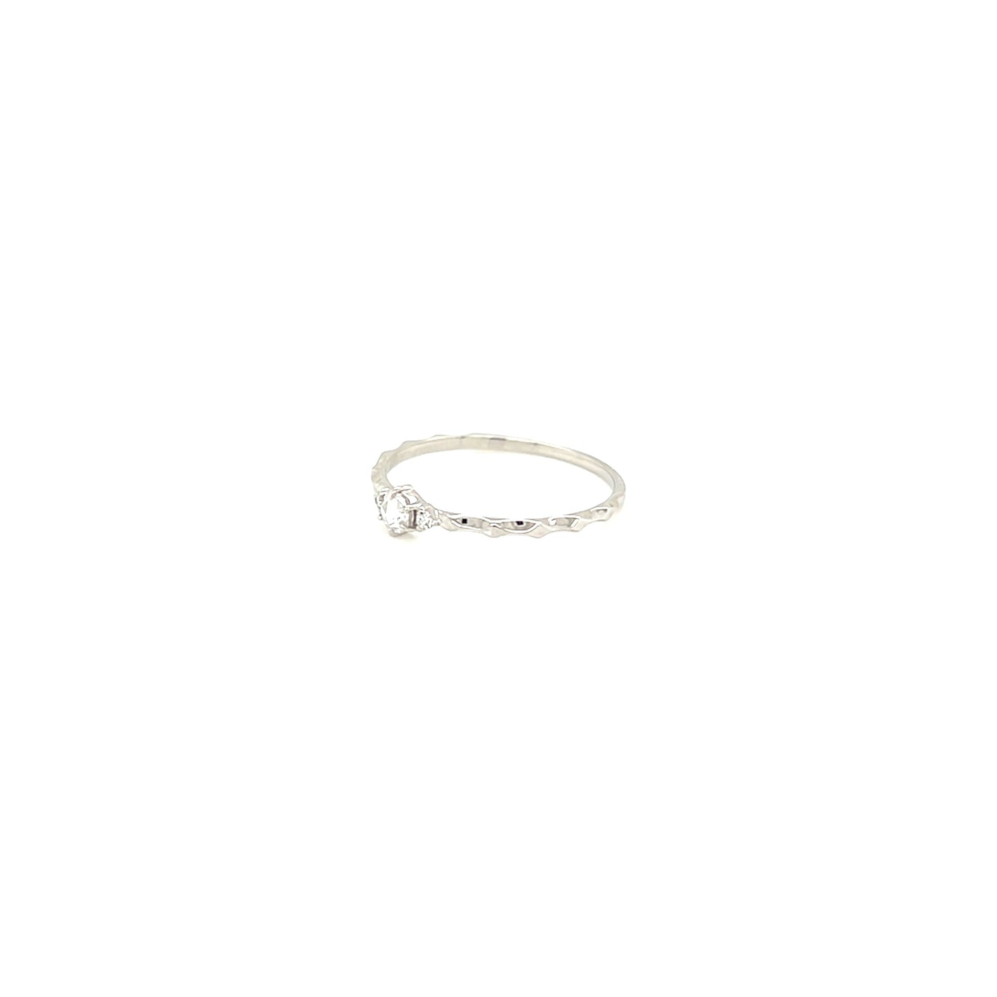 platinum ring with a small diamond on a white background