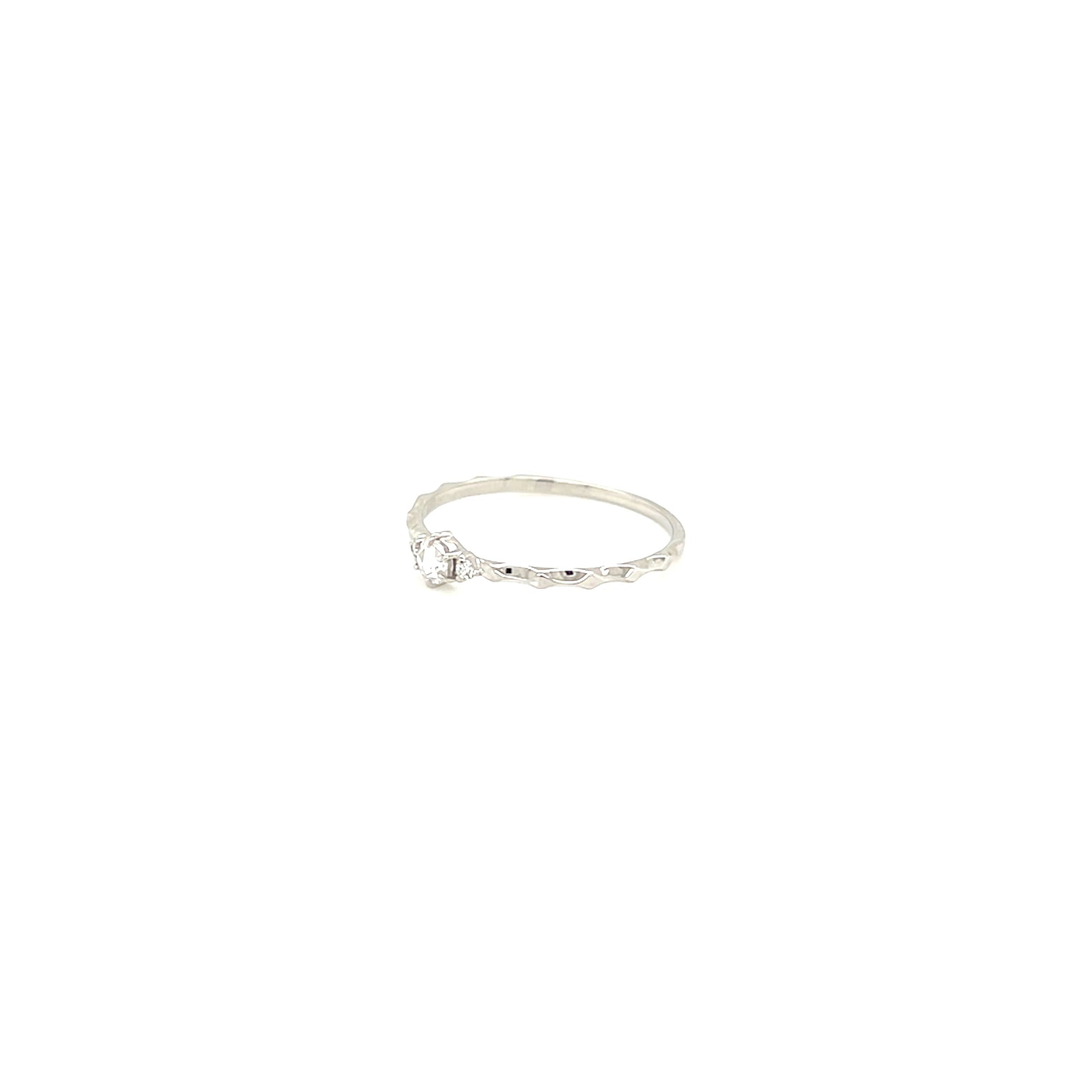 platinum ring with a small diamond on a white background