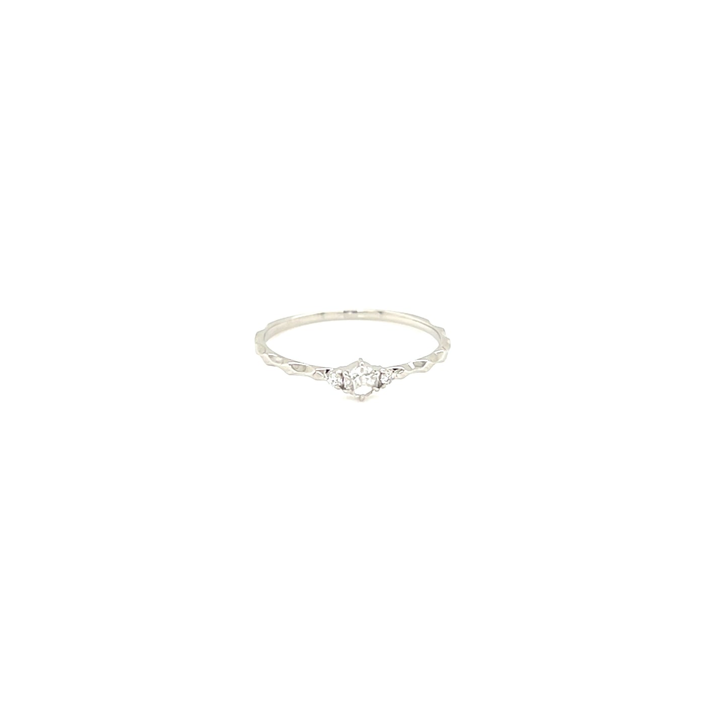 Platinum ring with a small diamond on a white background