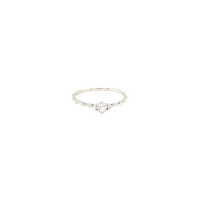 Platinum ring with a small diamond on a white background
