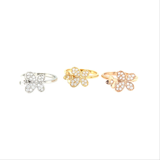 Three floral rings in gold and silver on a white background