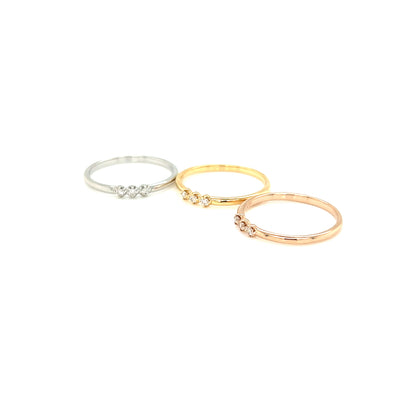 Two gold rings with small stones on a white background