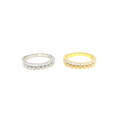Two diamond rings, one 18k white gold and one gold, on a white background