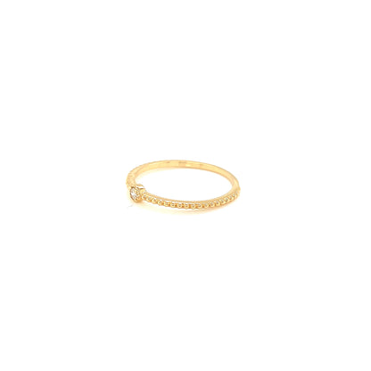 Gold ring with small diamonds on a white background