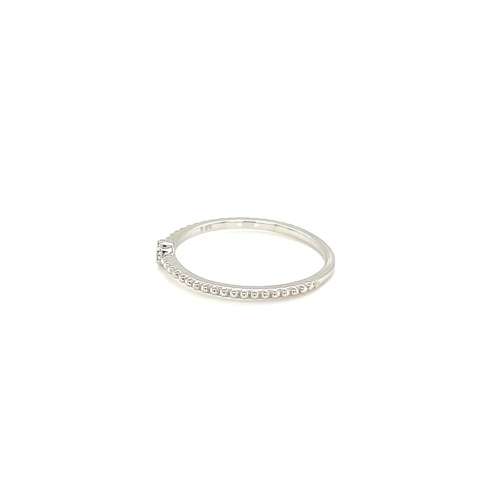 White gold ring with small stones on a white background
