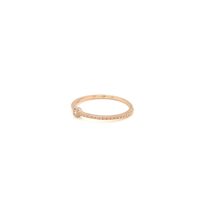 Rose gold ring with small diamonds on a white background