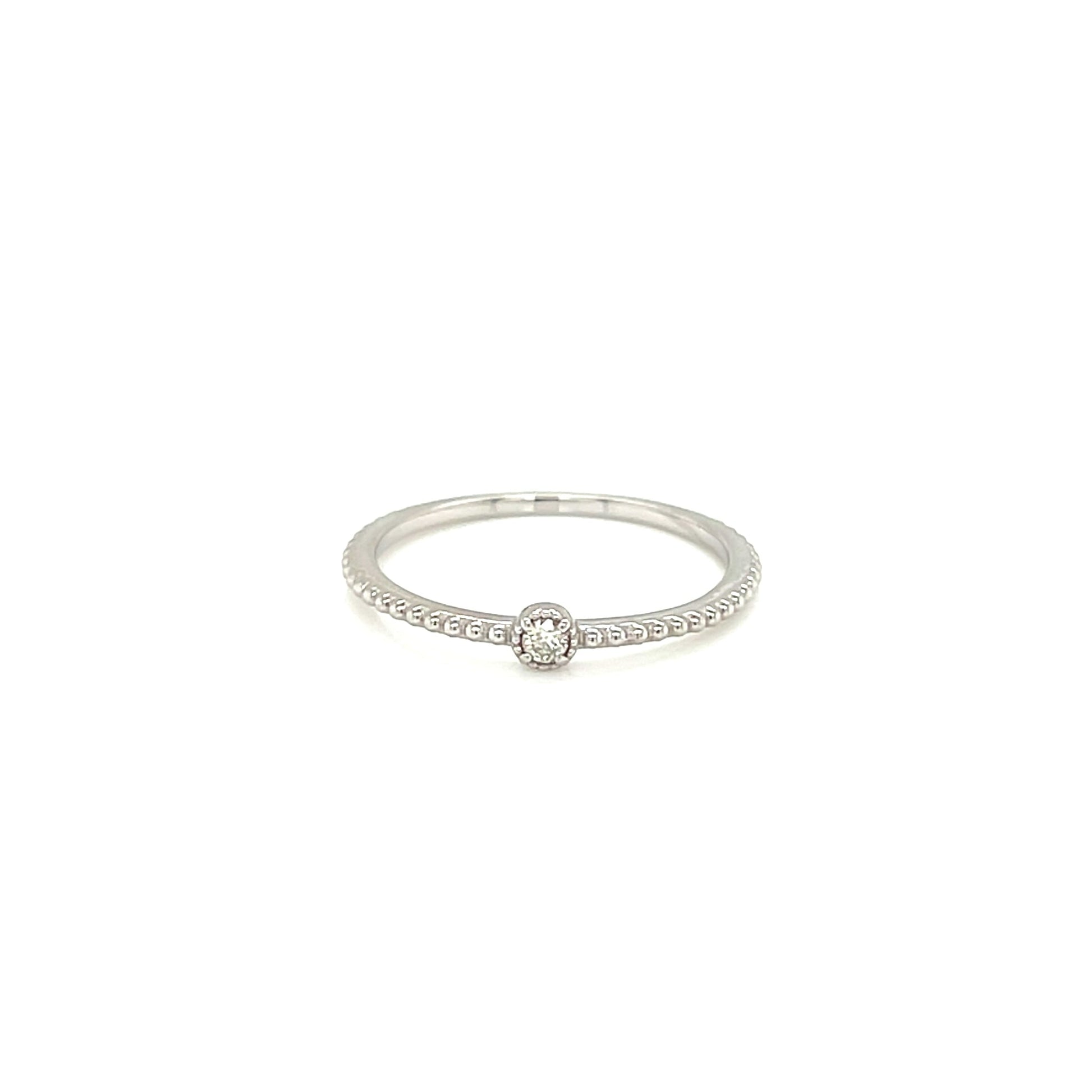 White gold ring with a small diamond on a white background