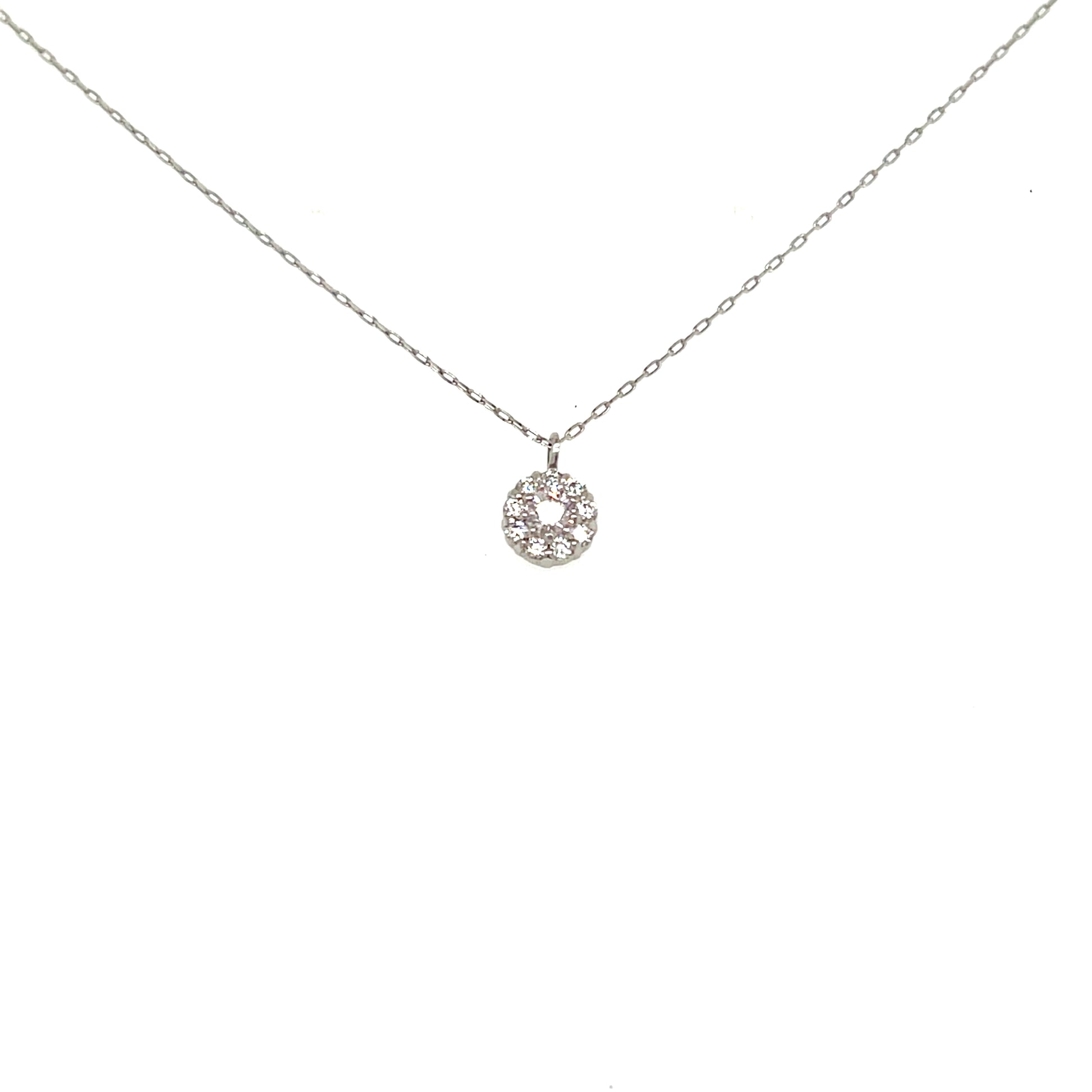 A delicate silver chain necklace with a small circular pendant set with clear stones, displayed against a solid white background.