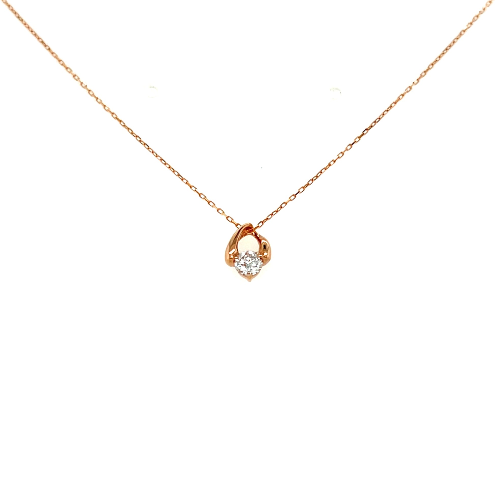 Rose gold necklace with a small pendant on a white background