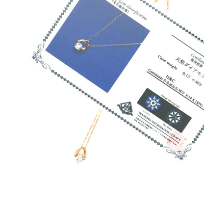 Gold necklace with diamond pendant on a white background