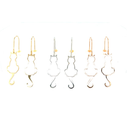 Cat-shaped drop earrings in gold and silver on a white background