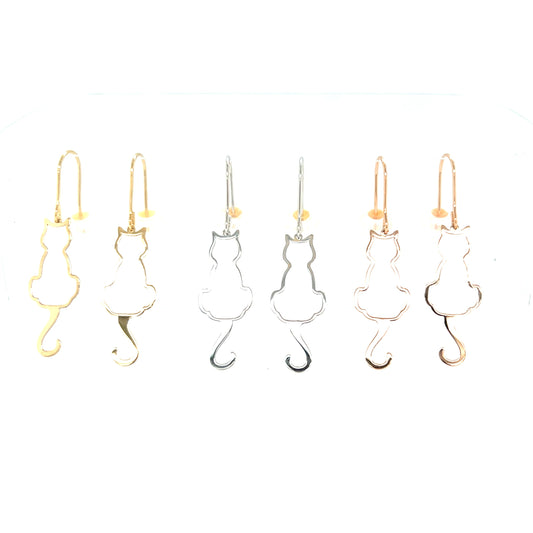 Cat-shaped drop earrings in gold and silver on a white background