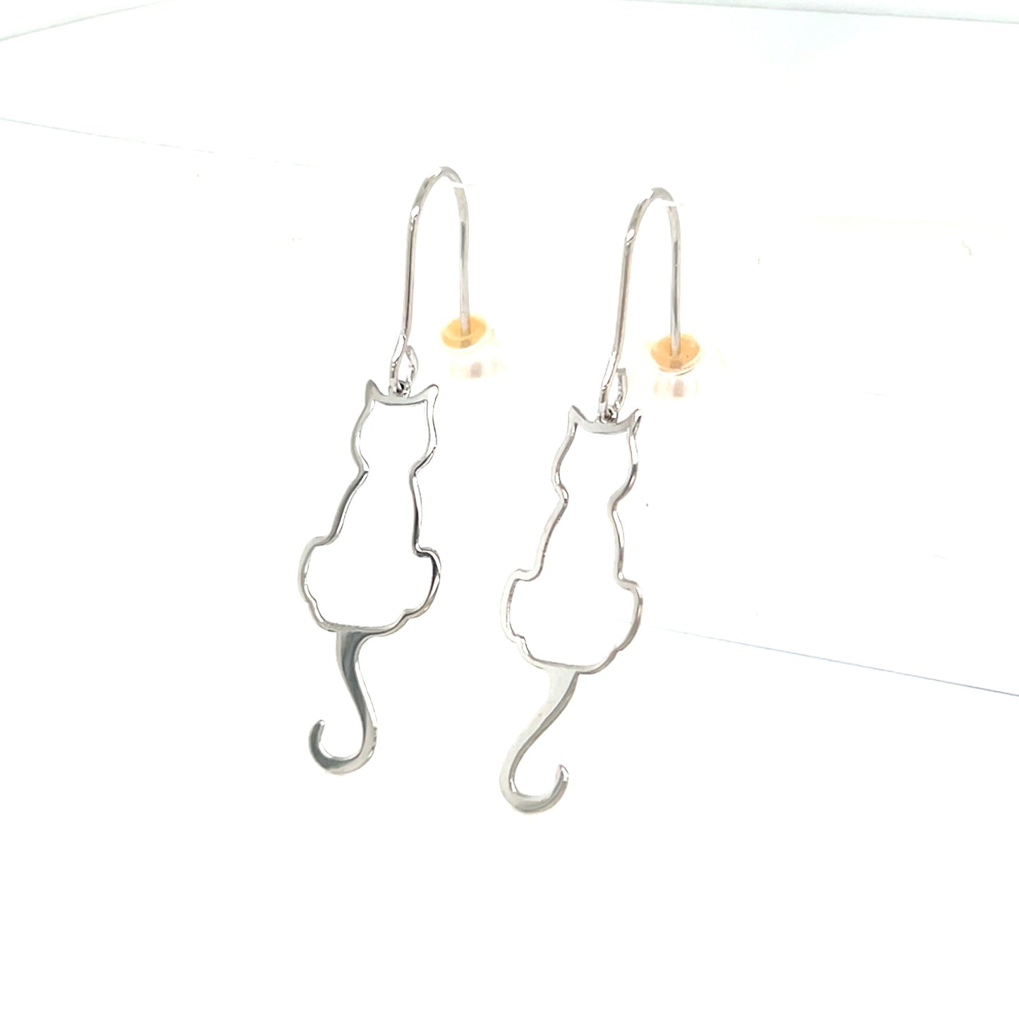 Silver cat-shaped earrings on a white background