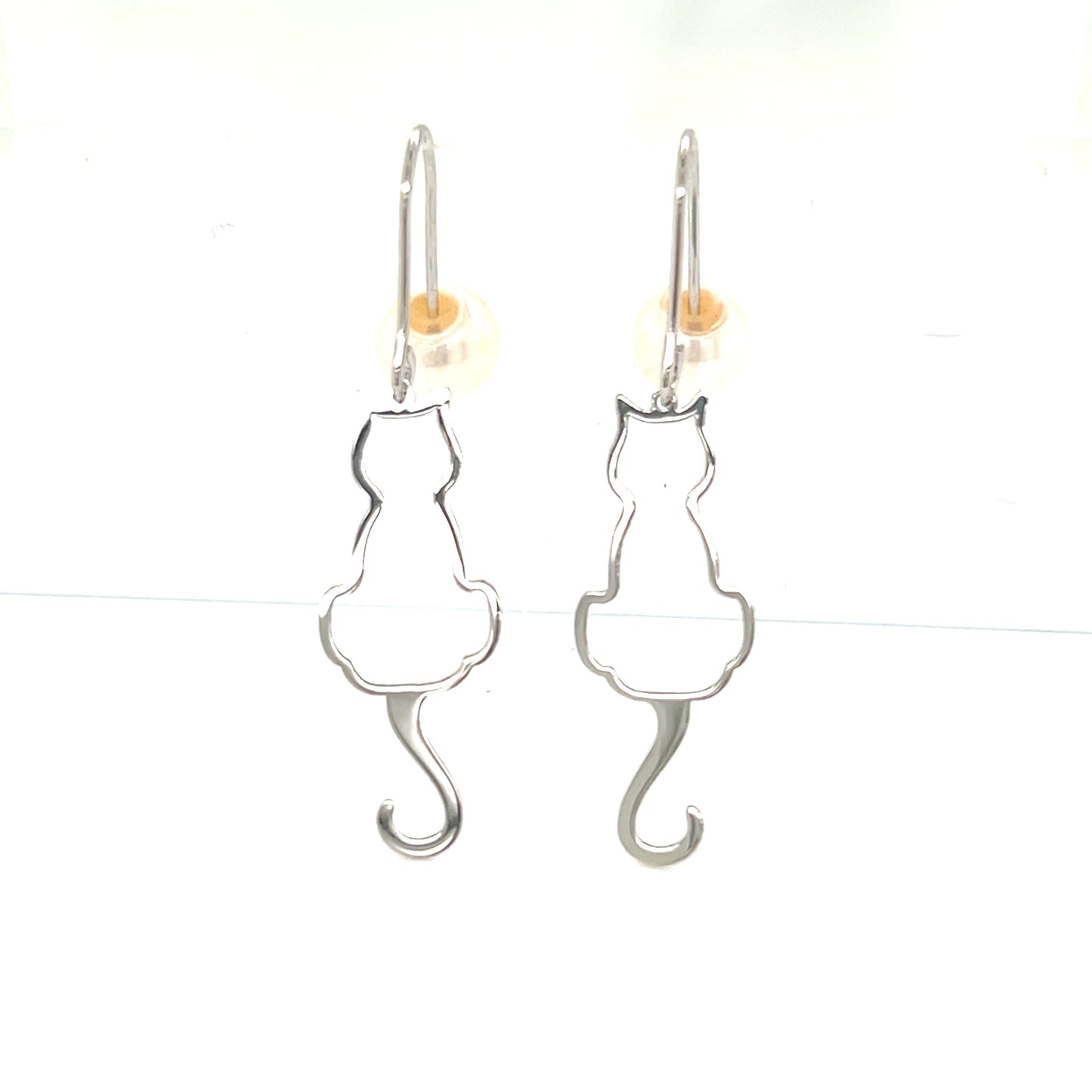 Cat-shaped earrings on a white background