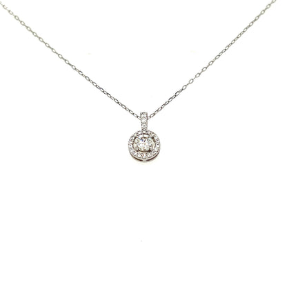 A silver-toned diamond necklace with a round halo pendant on a delicate chain, shown against a plain white background.