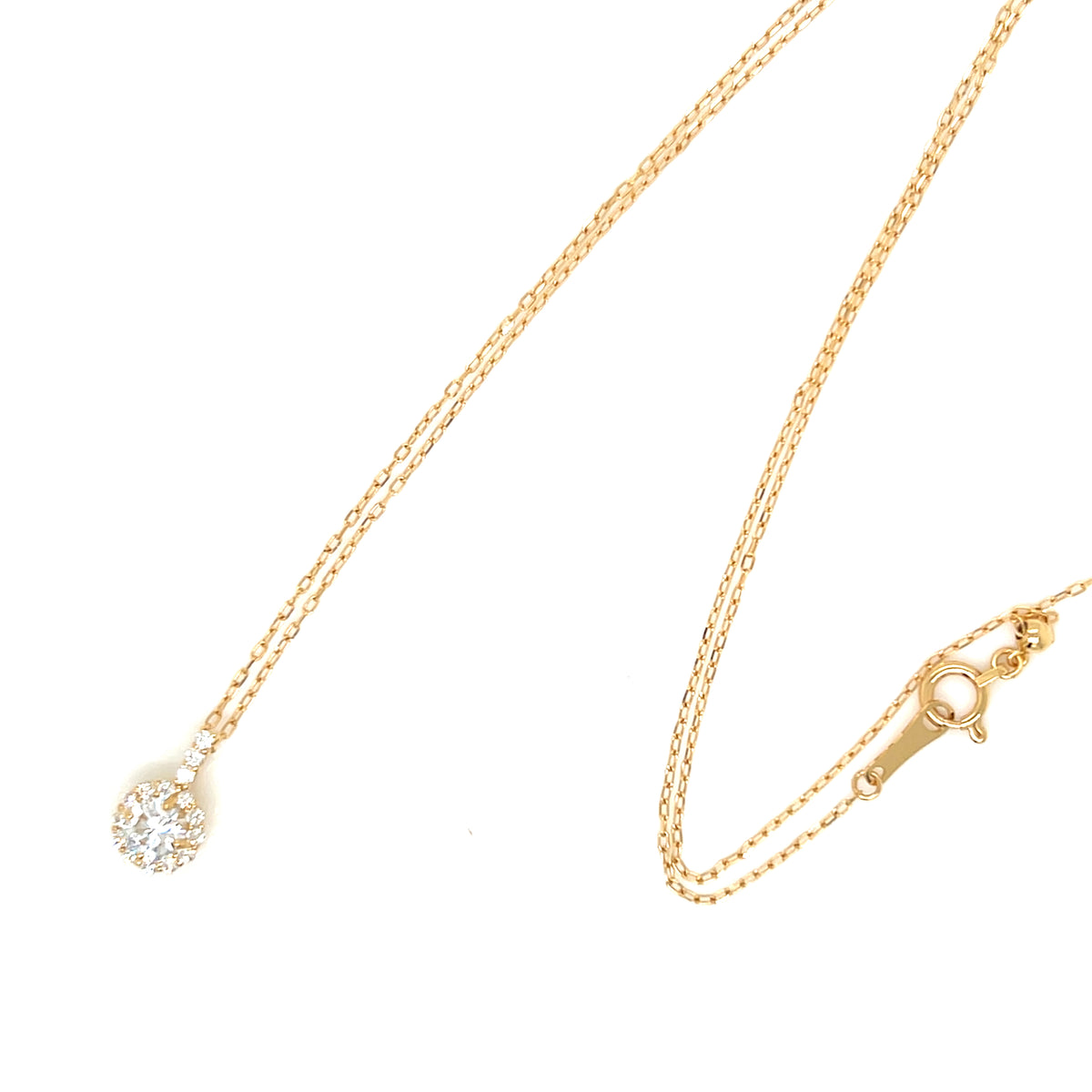 A delicate yellow gold chain necklace with a small round pendant set with clear gemstones, displayed on a clean white background.
