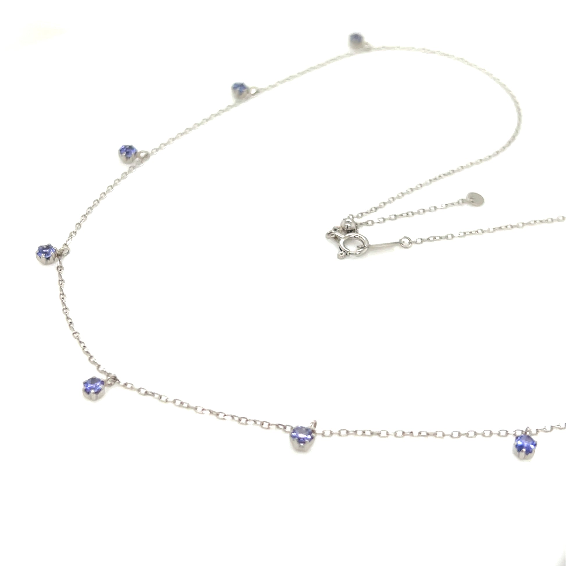 18k gold necklace with tanzanite on a white background