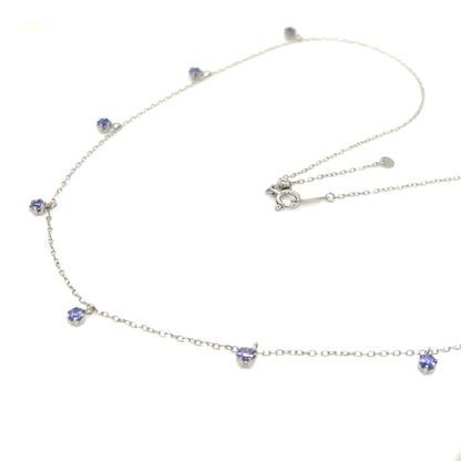 18k gold necklace with tanzanite on a white background