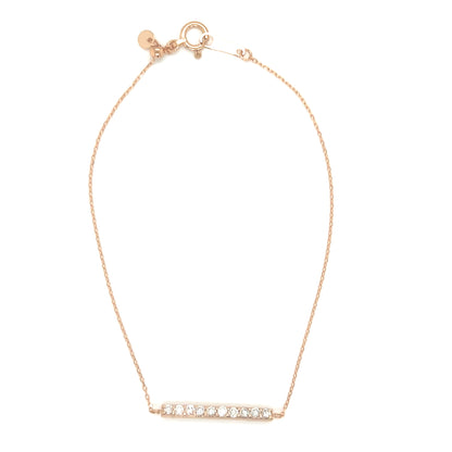 Gold necklace with a bar pendant on a white background