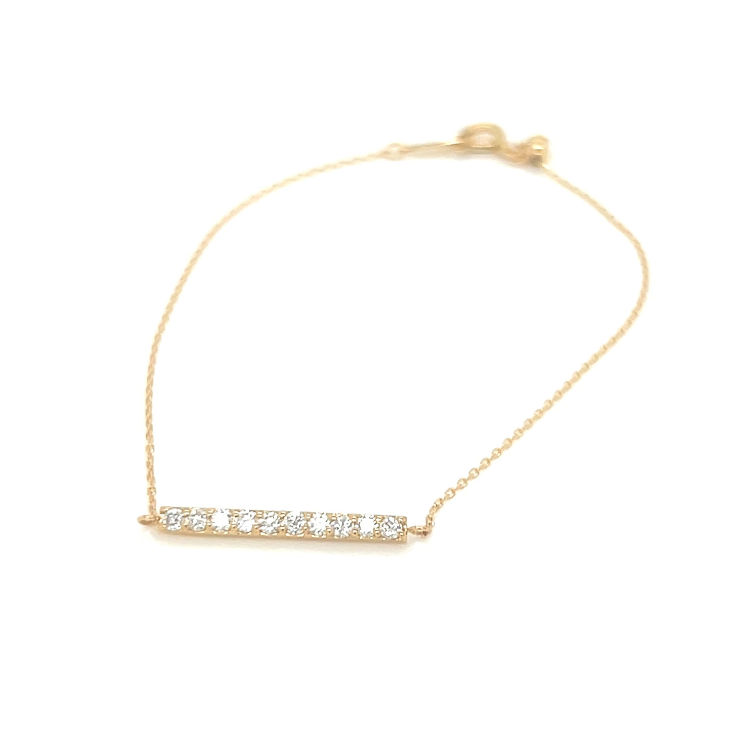 Gold bracelet with small diamonds on a white background