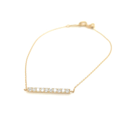 Gold bracelet with small diamonds on a white background