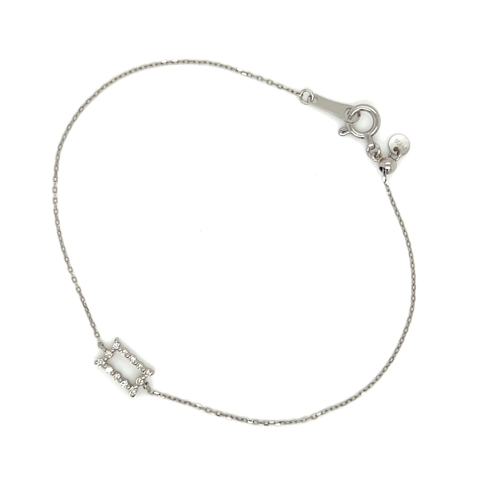 White gold bracelet with a small rectangular charm on a white background
