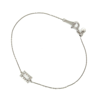 White gold bracelet with a small rectangular charm on a white background