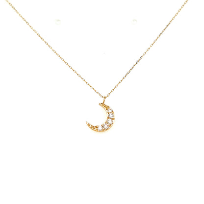 A delicate gold chain necklace with a crescent moon pendant adorned with small clear stones, displayed against a solid white background.