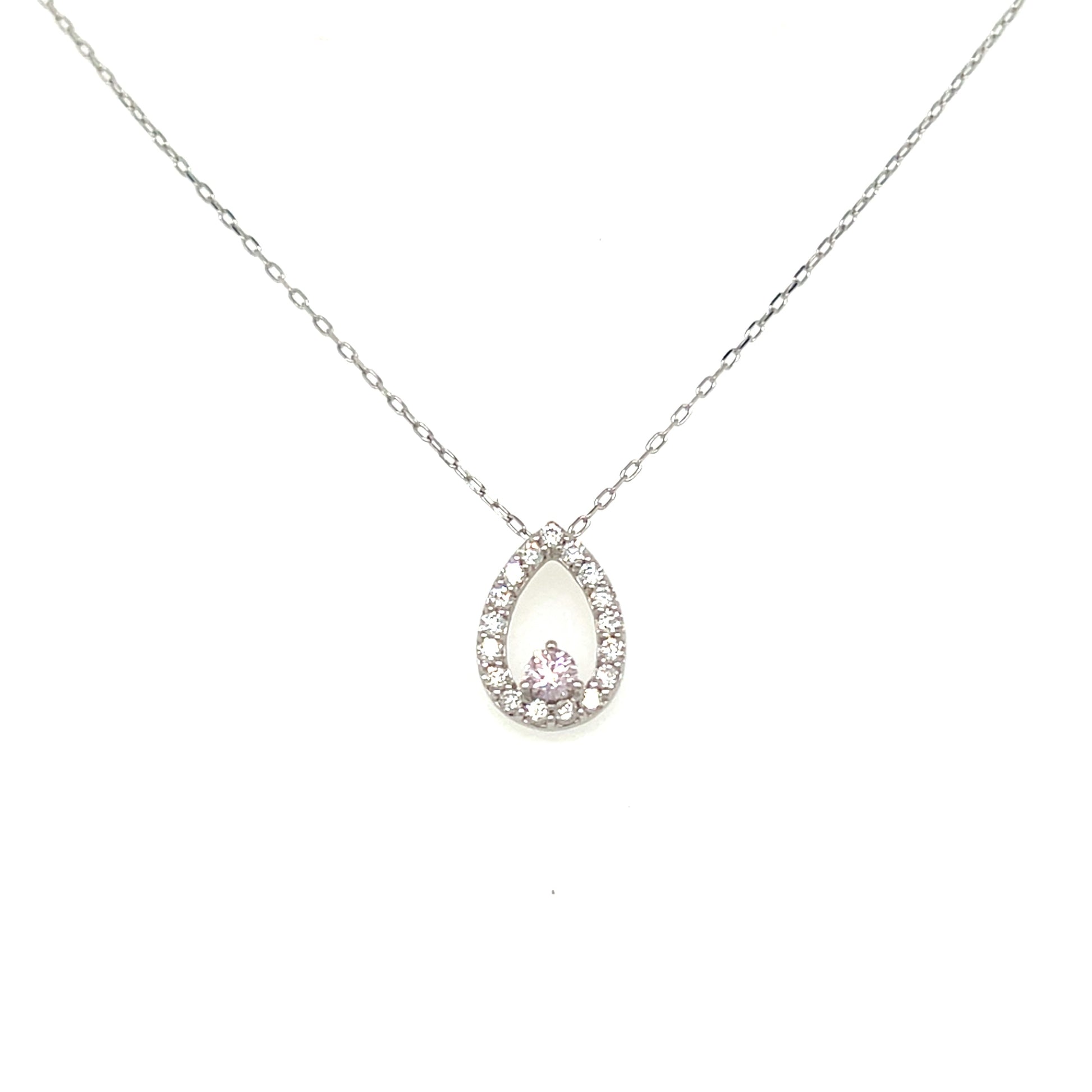 A delicate silver-toned chain necklace with a teardrop-shaped pendant. The pendant features a silver halo surrounded by small clear stones, with a central pink gemstone at the bottom, set against a plain white background.