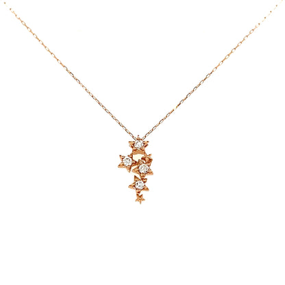 Rose gold necklace with a floral pendant on a white background