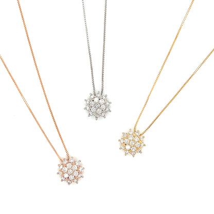 Three snowflake-shaped pendants on necklaces in rose gold, silver, and gold on a white background.