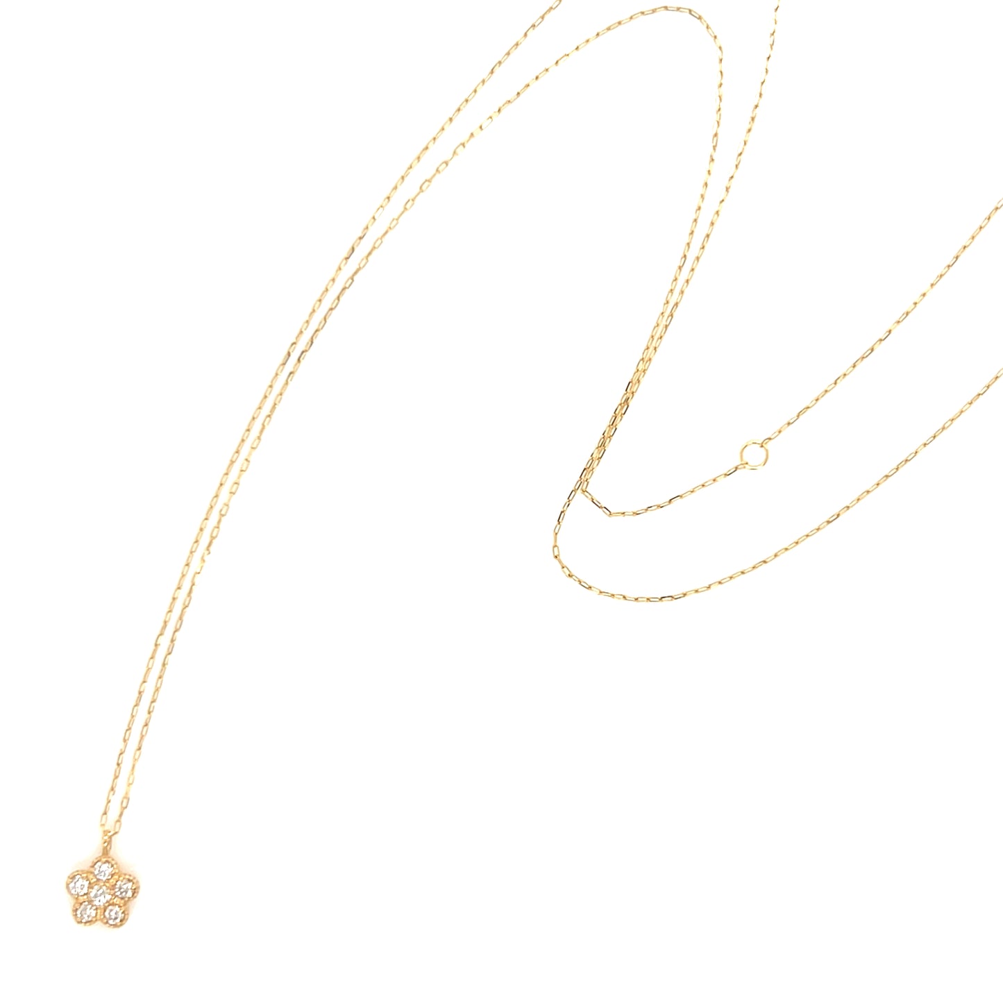 Gold necklace with a small flower pendant on a white background