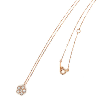 Rose gold necklace with a flower-shaped pendant on a white background