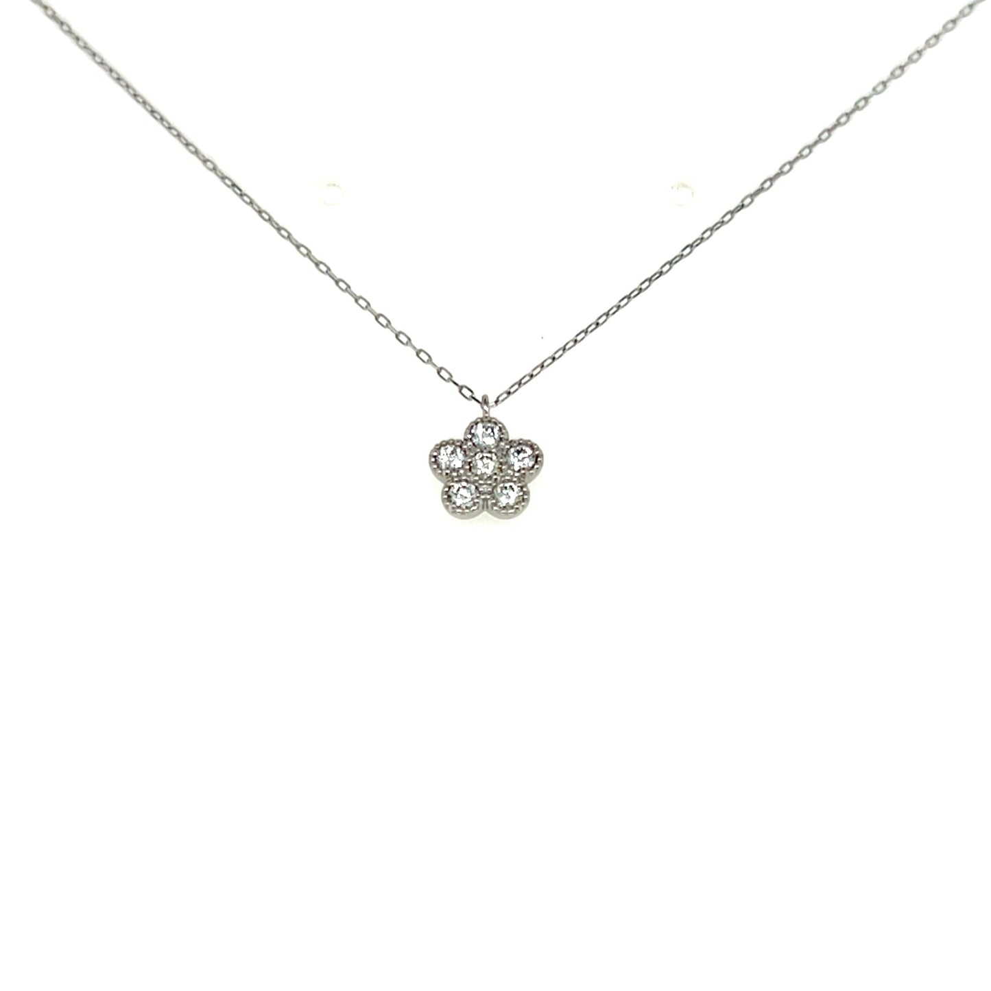 Flower-shaped silver pendant on a chain against a white background