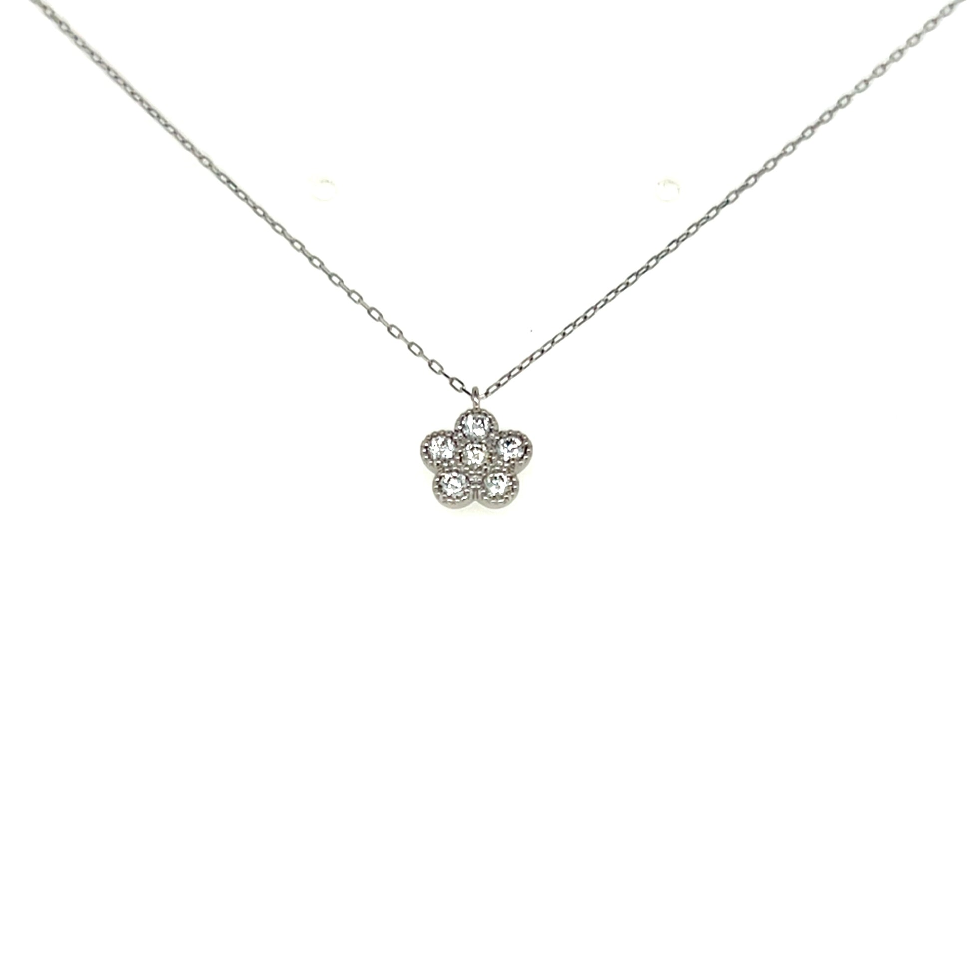 Flower-shaped silver pendant on a chain against a white background