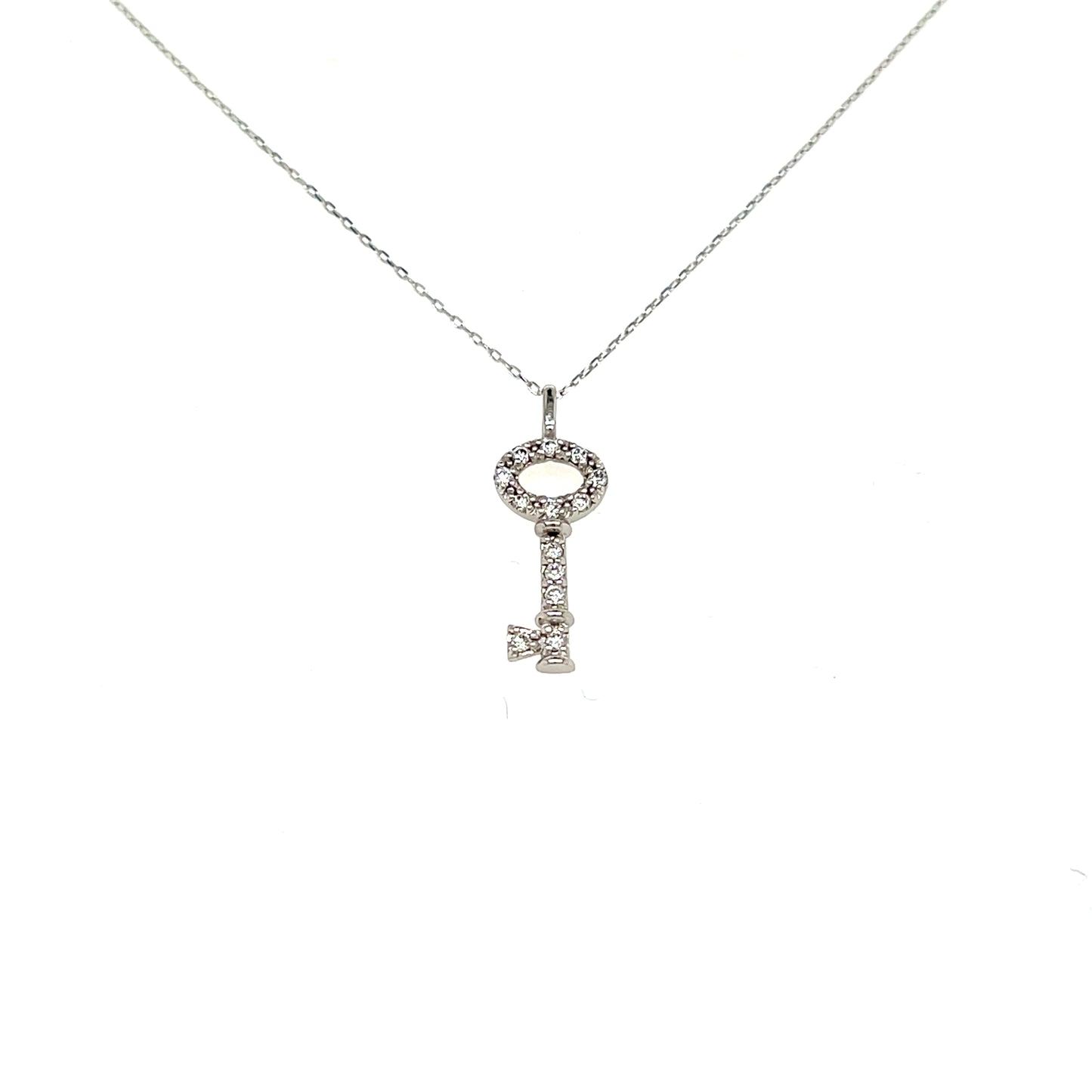 A silver key-shaped pendant necklace adorned with small clear stones, suspended from a delicate silver chain against a plain white background.
