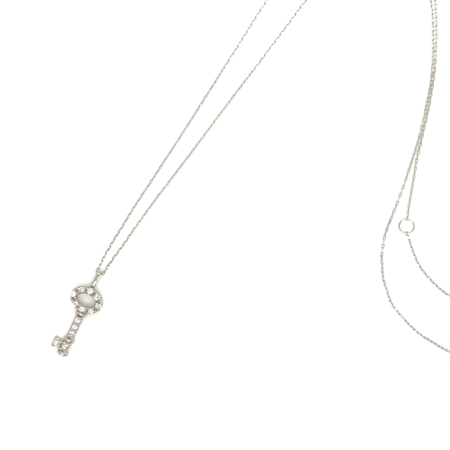 A silver key-shaped pendant necklace adorned with clear rhinestones, shown on a delicate chain against a plain white background.